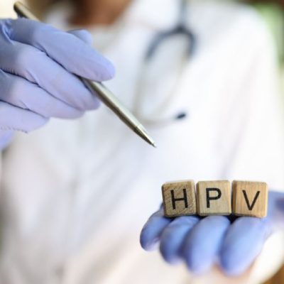 closeup-of-doctor-hands-holding-wooden-cubes-with-word-hpv-practitioner-pointing-with-pen-on